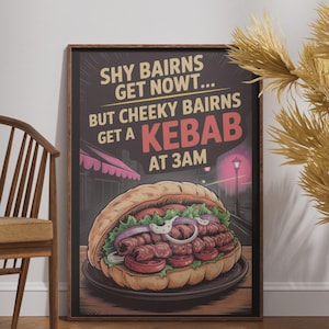 May include: A framed rectangular wall art print featuring a graphic illustration of a kebab in a pita bread with lettuce, tomato, and onion. The text reads: SHY BAIRNS GET NOWT... BUT CHEEKY BAIRNS GET A KEBAB AT 3AM. The background shows a dark street scene.