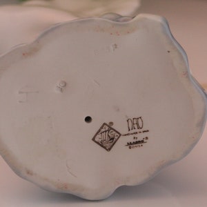 Bottom of figure with NAO by Lladro stamp