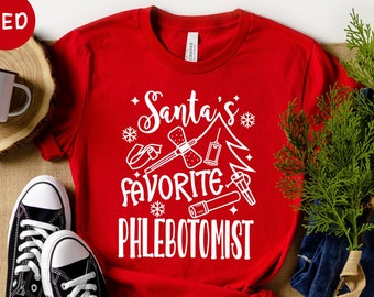 May include: Red t-shirt with white text that reads "Santa's Favorite Phlebotomist" and a graphic of medical supplies, including a bandage, syringe, and tourniquet.