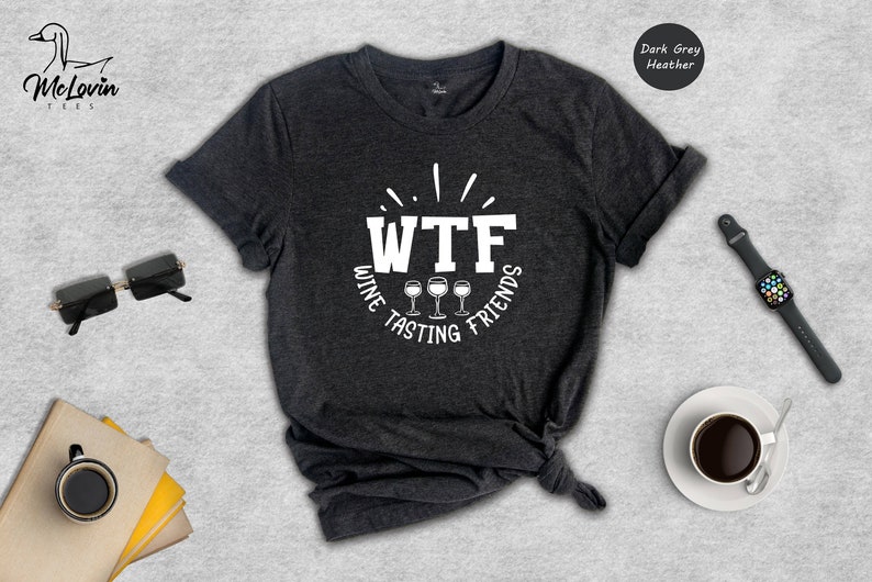 May include: Dark grey heather t-shirt with a white graphic that says "WTF Wine Tasting Friends" with three wine glasses.