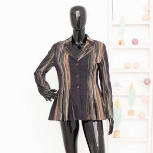 May include: A black and brown striped blazer with a button fastening. The blazer has a fitted silhouette and a slightly flared hem.