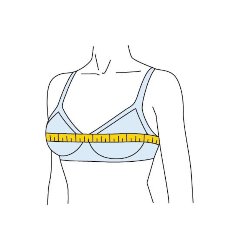 May include: A white bra with a yellow measuring tape across the bust line.