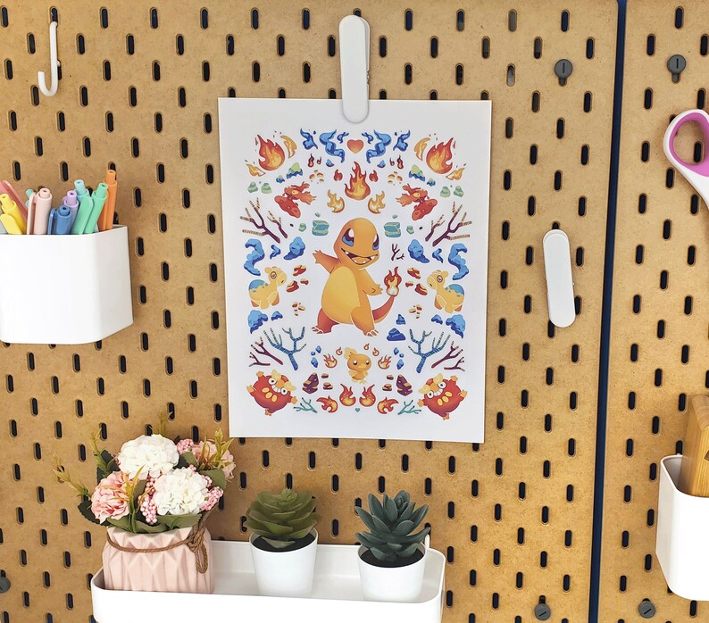 May include: A printable 8.5 x 11 inch sheet of paper with a colorful illustration of a cartoon character. The character is orange and has a red, white, and blue design. The character is surrounded by other smaller cartoon characters.