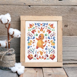 May include: A framed print featuring a cartoon illustration of a fire-type Pokemon, Charmeleon, surrounded by flames, rocks, and other fire-type Pokemon. The print has a white background and a wooden frame.