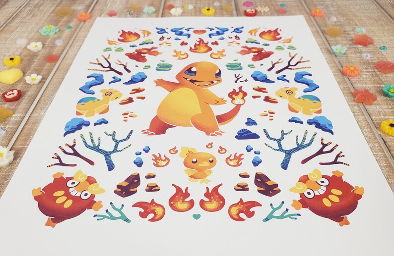 May include: A colorful print featuring a cartoon fire-type Pokemon, Charmander, surrounded by flames, rocks, and other fire-type Pokemon. The print is on a white background.