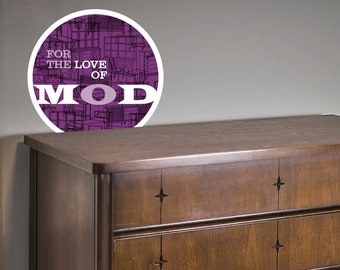 May include: A mid-century modern dresser with four drawers and a dark wood finish. The dresser has star-shaped inlays on the top drawer and silver-toned handles on each drawer.