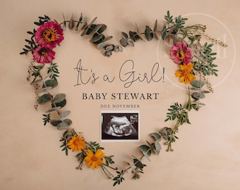 May include: It's a Girl! Baby Stewart Due November. A heart-shaped arrangement of eucalyptus leaves and pink and yellow flowers with a black and white ultrasound image in the center.