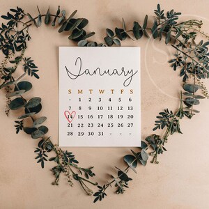 May include: A white calendar with the month of January displayed. The number 14 is circled with a red heart.