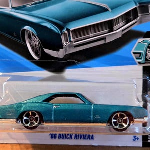 May include: A teal 1966 Buick Riviera die-cast toy car in its original blister pack packaging. The packaging features a large illustration of the vehicle at the top, the text 66 BUICK RIVIERA at the bottom, and a 2/5 series indicator.