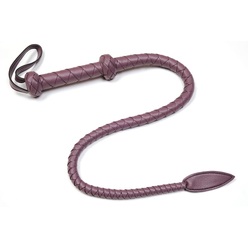 May include: A purple leather braided whip with a knotted handle and a pointed tip.