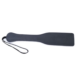 May include: A black leather paddle with a strap. The paddle is about 15 inches long and 4 inches wide.