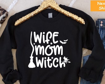 May include: Black sweatshirt with white text that reads "Wife Mom Witch" with a broom and bats graphic.