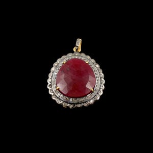 May include: A red gemstone pendant with a silver and gold setting. The pendant is surrounded by small diamonds.