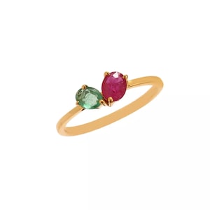 May include: A gold ring with a red ruby and a green emerald gemstone.