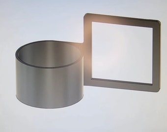 May include: A silver metal cup holder with a rectangular frame attached to the side. The cup holder is designed to hold a standard-sized cup or mug.