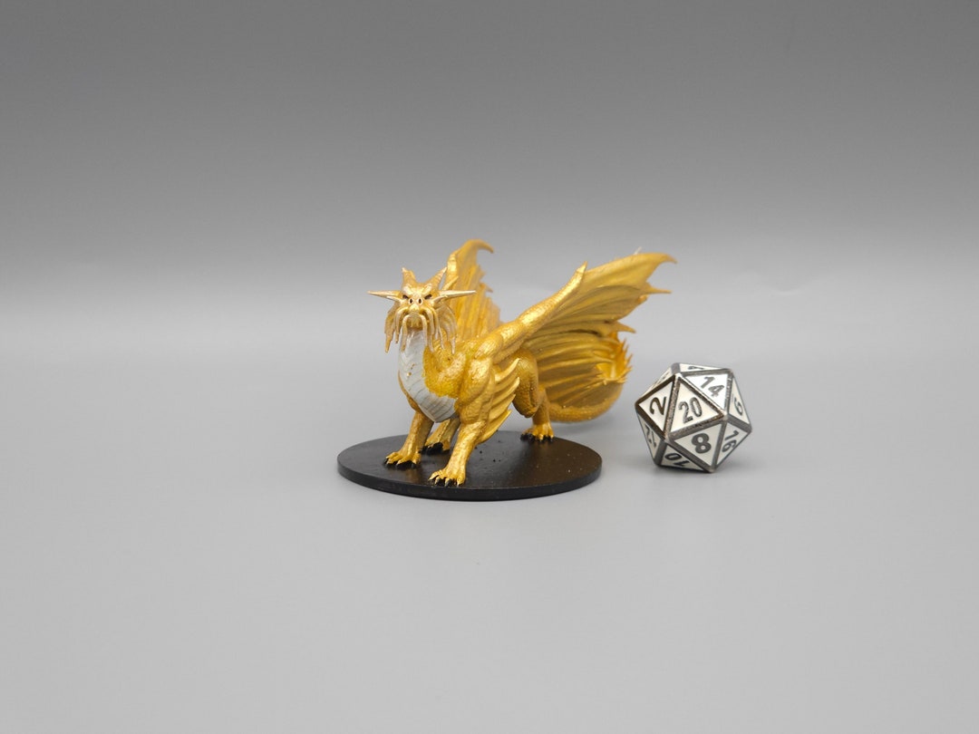 Behold a young gold dragon miniature hand painted or primed d d ttrpg