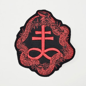 May include: Embroidered patch featuring a red Leviathan cross symbol on a black background, encircled by red snakes. The patch has a black border and is designed for application on clothing or accessories.
