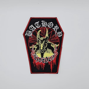 May include: Black coffin-shaped patch with the band name "Bathory" in white and "Hordes" in red. The patch features a yellow and black illustration of a horned figure within a red star and circle design.