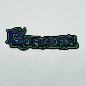 Gorguts lila och grön logotypformad kant | Broderad rygglapp