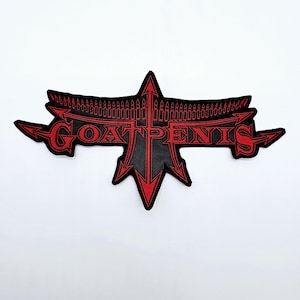 May include: Black and red embroidered patch with the text "GOAT PENIS" in a gothic font. The patch has a stylized design with arrows and bullet-like shapes, suitable for jackets or bags.
