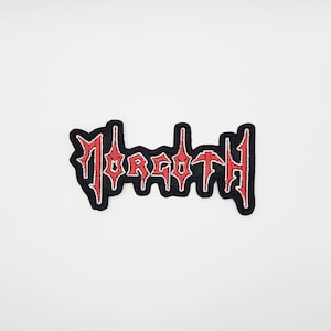 May include: Embroidered patch featuring the word "Morgoth" in red, gothic lettering. The patch has a black border and is designed for application on clothing or accessories. The design is centered on a white background.