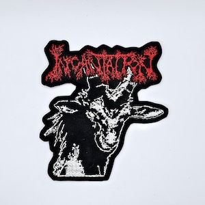 May include: Embroidered patch featuring the word "Incarnatory" in red, stylized text above a black and white illustration of a goat's head. The patch has a black border and is likely for clothing or accessories.