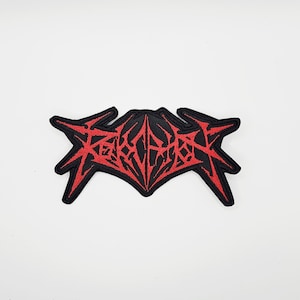 May include: Embroidered patch in black and red. The patch has a striking, angular design in red against a black backdrop. The patch is likely intended for application on clothing or accessories.