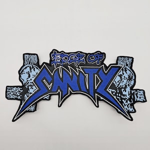 May include: Embroidered patch with the words "ROCK OF SANITY" in blue and white, with a stylized font. The patch has a black border and features skull and crossbones designs on each side.