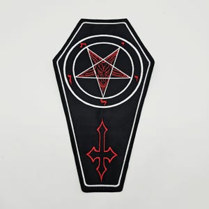 May include: A coffin-shaped embroidered patch featuring a black background with a white border. The design includes a red pentagram containing a goat head, surrounded by a white circle with red Hebrew characters, and a red inverted cross below.