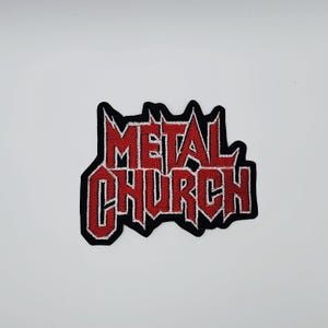 May include: Embroidered patch featuring the words "METAL CHURCH" in red, stylized lettering with a black border. The patch has a jagged, gothic design, suitable for jackets, bags, or other fabric items.