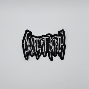 May include: A black and white embroidered patch with the text "DECREPIT BIRTH" in a gothic font. The patch has a jagged border and is set against a white background.
