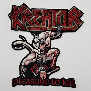 May include: Embroidered patch featuring the word "KREATOR" in red with yellow stitching. Below, a detailed illustration of a muscular figure with a horned head and the text "pleasure to kill" in red.