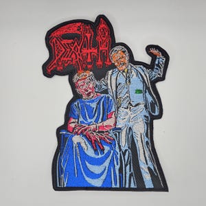 Broderad lapp med formad kant och dödsmotiv