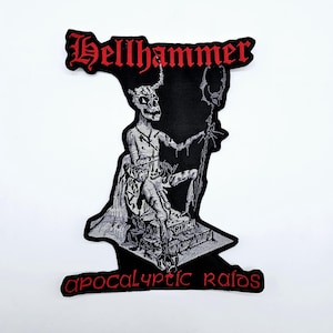 May include: Black patch with red embroidered text reading "Hellhammer" above a skeletal figure holding a staff. The figure is seated on a stone structure, with the words "apocalyptic raids" embroidered below.