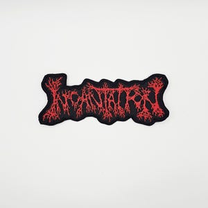May include: A black embroidered patch with the word "INCANTATION" in red, stylized, gothic lettering. The patch has a jagged, irregular border and is set against a white background.