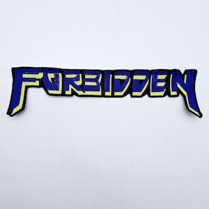 May include: Embroidered patch with the word "FORBIDDEN" in bold, stylized lettering. The letters are blue with a yellow outline and a black border. The patch has a rectangular shape with extended edges.