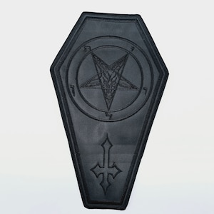 May include: Black leather patch shaped like a coffin with an embroidered pentagram and inverted cross.