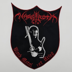 May include: Black shield-shaped patch with red trim and embroidered text and imagery. The patch features the word "Nargaroth" in red, a figure holding a sword, and the words "Black Metal ist Krieg."