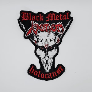 May include: Black metal patch with a white and red devil-like figure. The patch features the words "Black Metal" and "Venom" in red gothic lettering, with "holocaust" in red at the bottom. The patch is black with a white border.
