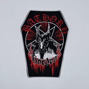 May include: Black coffin-shaped patch with the text "BATHORY" in red gothic lettering above a black goat head with a pentagram and the word "Hordes" in red. Red flames and lines surround the goat.