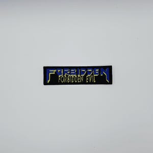 Op de afbeelding: Een rechthoekige zwarte patch met het woord "FORBIDDEN" in blauw en geel, boven "FORBIDDEN EVIL" in geel. De patch is waarschijnlijk bedoeld voor kleding of accessoires.