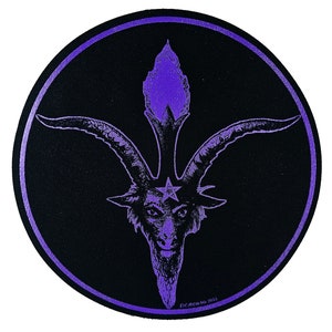 May include: Purple and black round sticker with a pentagram and a goat head with horns. The text "The Acolyte" is at the bottom of the sticker.