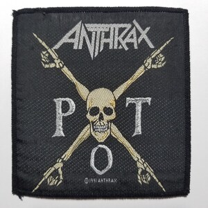 May include: Black and white embroidered patch with the band name "Anthrax" and the text "P.O.T."  The patch features a skull with crossed bones and the copyright symbol with "1991 Anthrax".