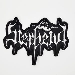 May include: Black and white embroidered patch with the word "Sleepdead" in a gothic font. The patch features a stylized illustration of a figure. The patch is likely for clothing or accessories.