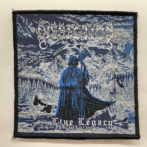 May include: Black and white embroidered patch with a blue and black image of a hooded figure holding a scythe. The text "Dissection" is at the top of the patch and "Live Legacy" is at the bottom with the text "Nuclear Blast 2003" underneath.