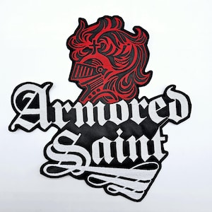 May include: Embroidered patch featuring a red knight's helmet and flowing hair design. The patch has the words "Armored Saint" in a gothic font, with a black background and white border.