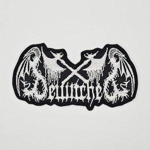 Könnte beinhalten: Schwarz-weißer, gestickter Aufnäher mit einem geflügelten Dämonen-Design, gekreuzten Äxten und dem Wort "Belphegor". Der Aufnäher hat einen schwarzen Rand und ist für Kleidung oder Accessoires geeignet.
