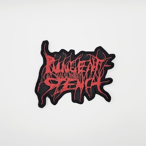 May include: Black embroidered patch with the text "RUNGENT SENA" in red, stylized lettering. The patch has a jagged, irregular border. The design is likely for a band or a similar subculture.