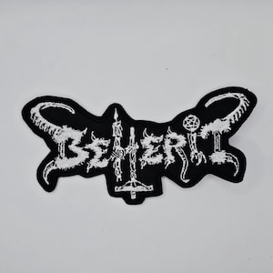 Beherit vit logotypformad kantbroderad lapp