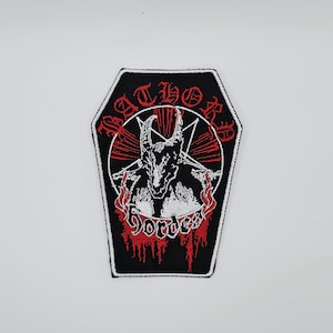 May include: Black, coffin-shaped patch with a red and white design. The patch features a horned figure inside a red circle, with the words "BATHORY" and "HORDES" in red lettering. The patch has a white border.